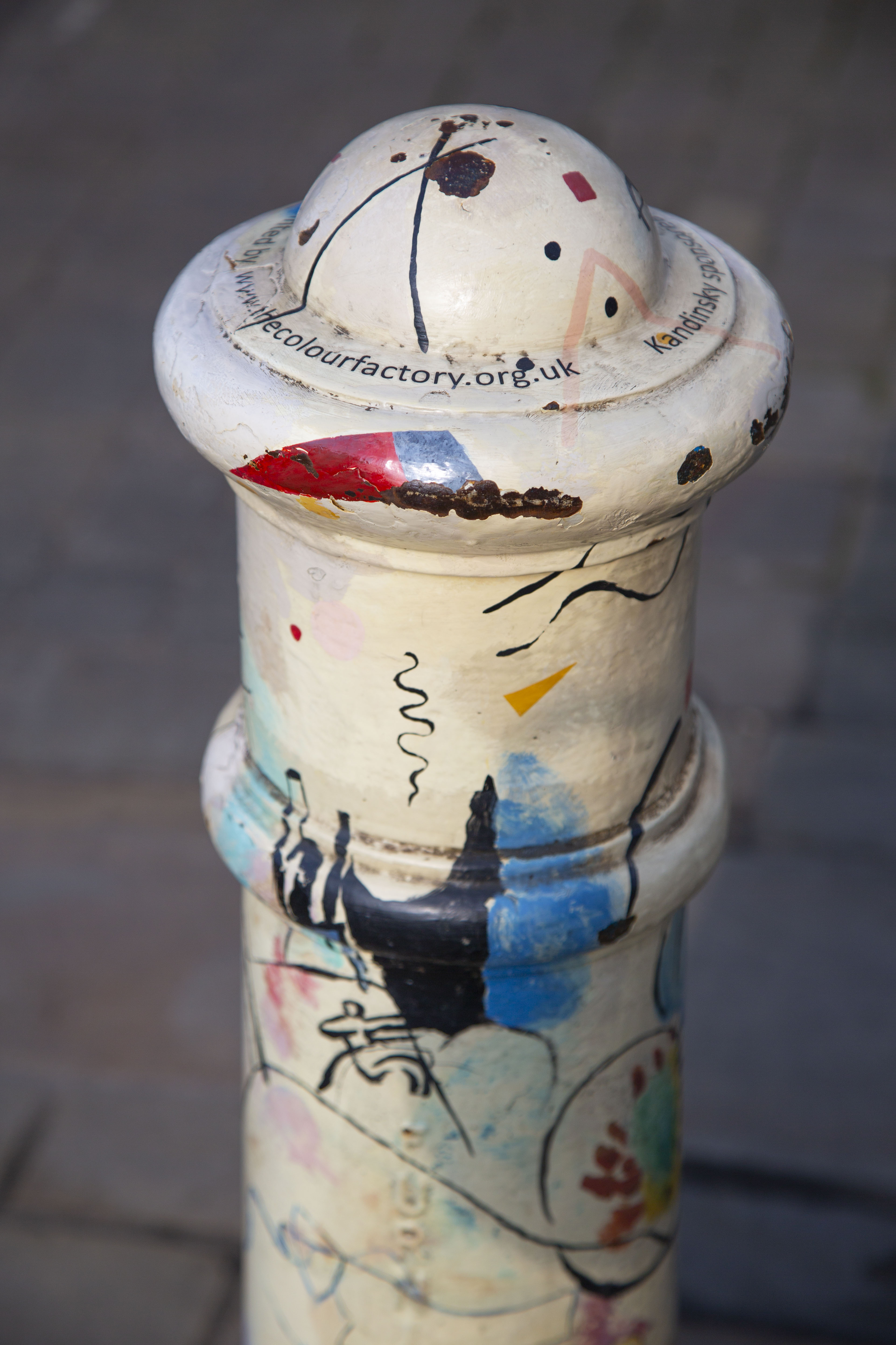 A bollard painted in the style of one of Kandinsky's compositions
