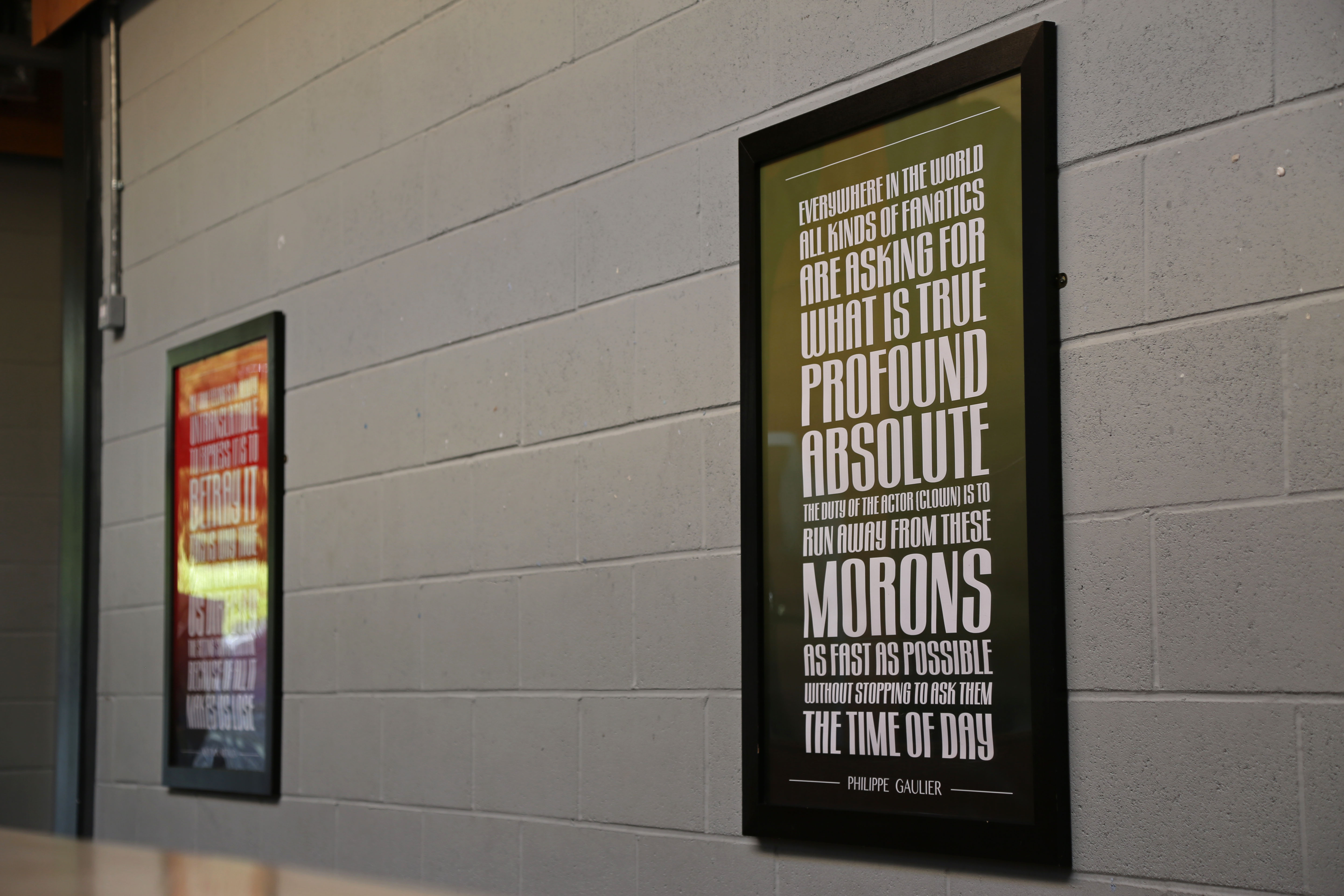 Two framed photos of quotes on the walls on the Paul Chamberlain Buildling.