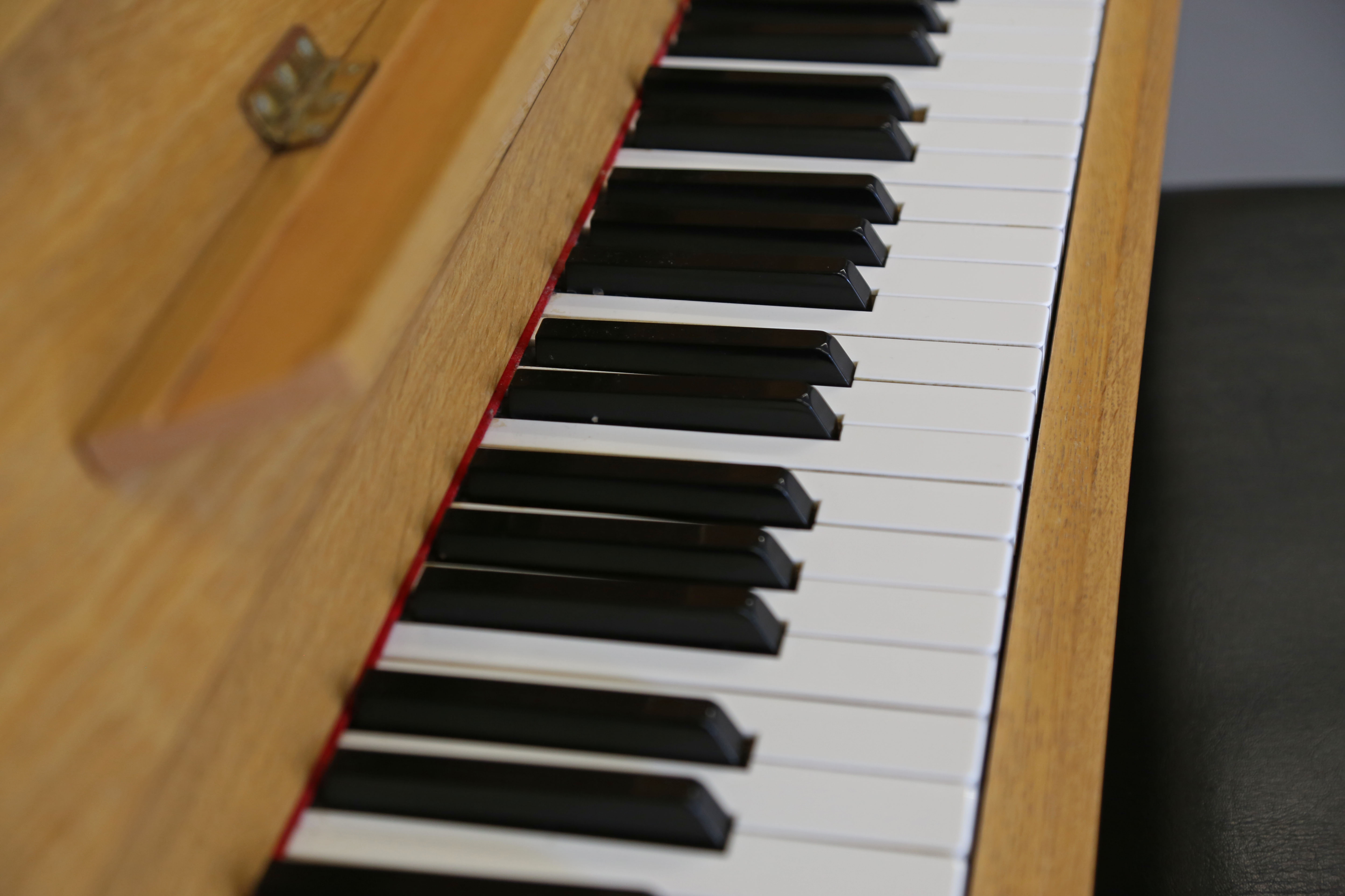 Close up on a piano, complete with keys and lid