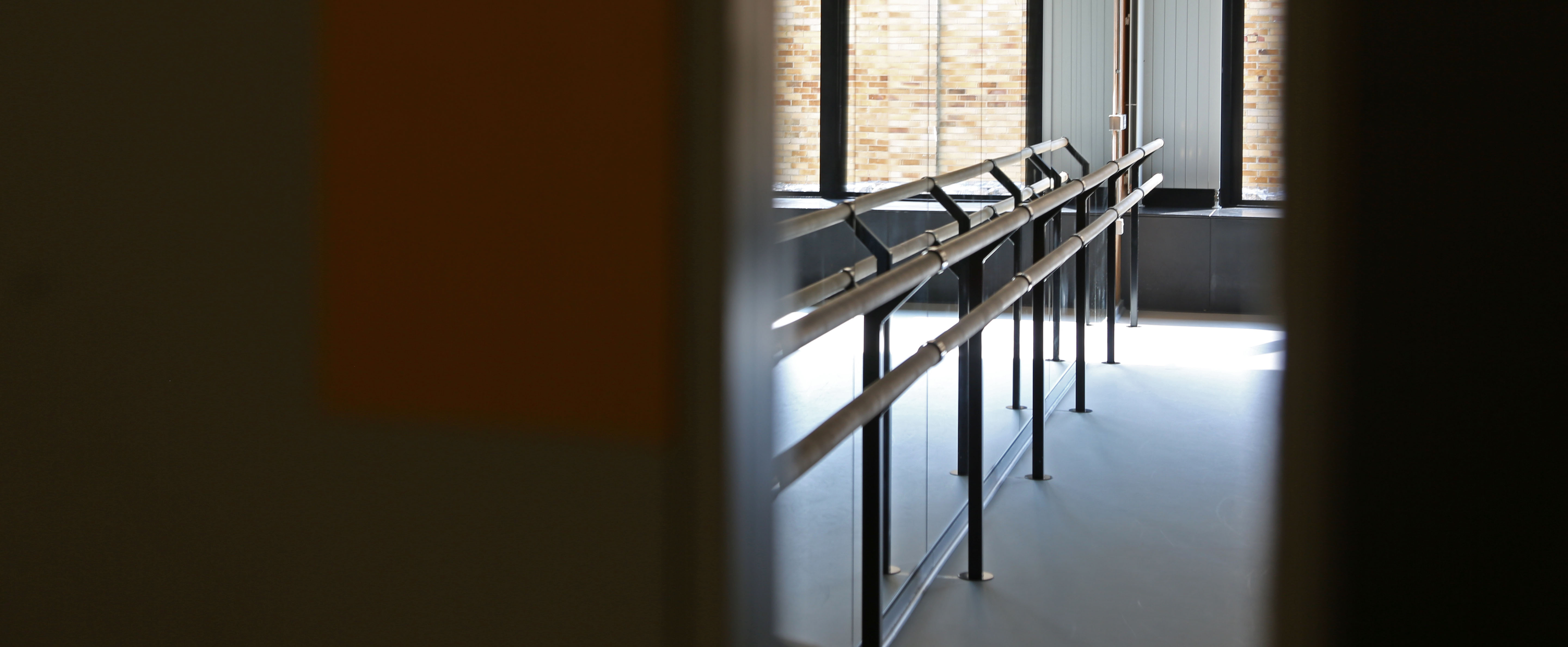 A picture taken through the window of PCB 3, focusing on the ballet bars and mirror