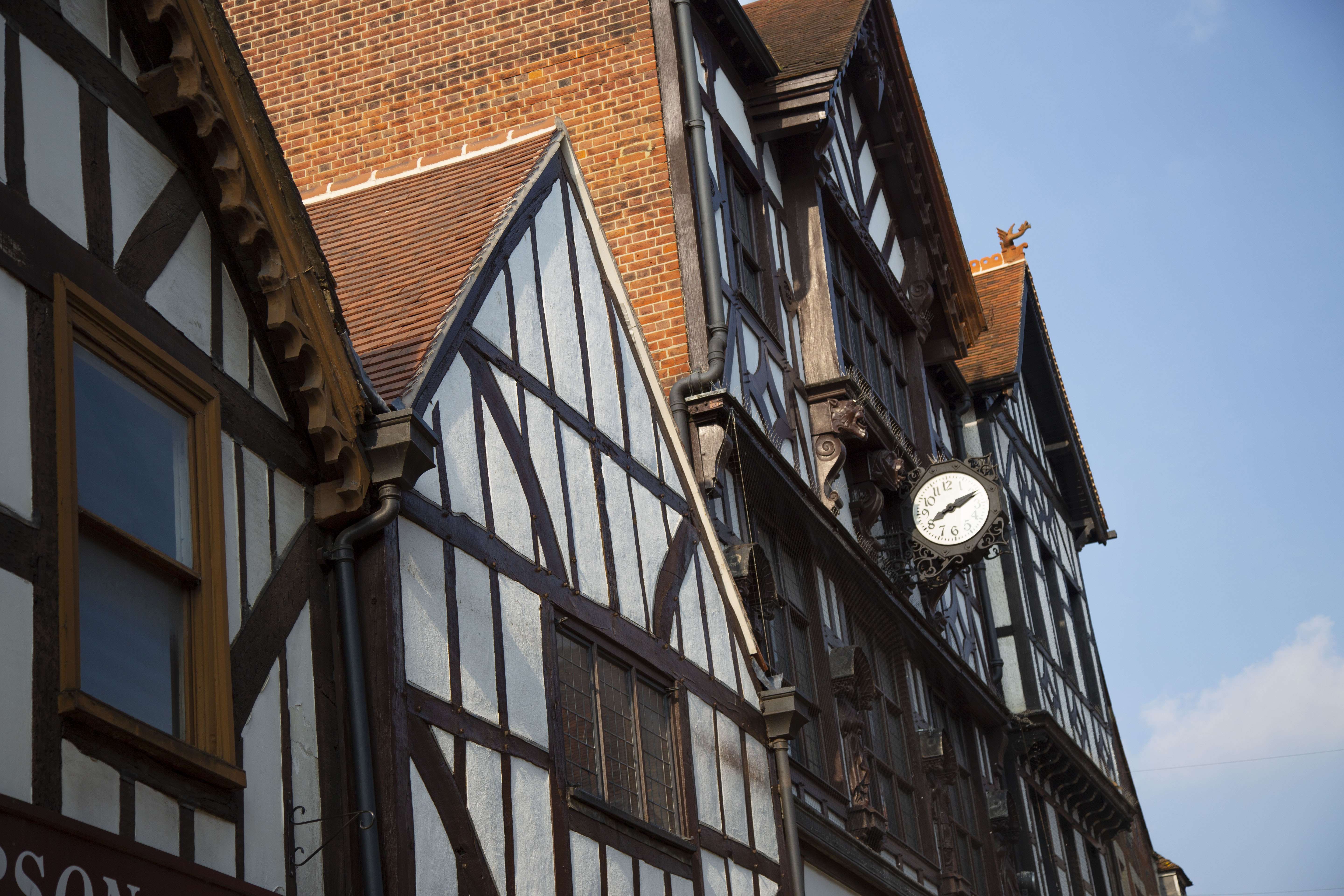 The top stories of some of Winchester's shops, decorated in a white and black Tudor visage