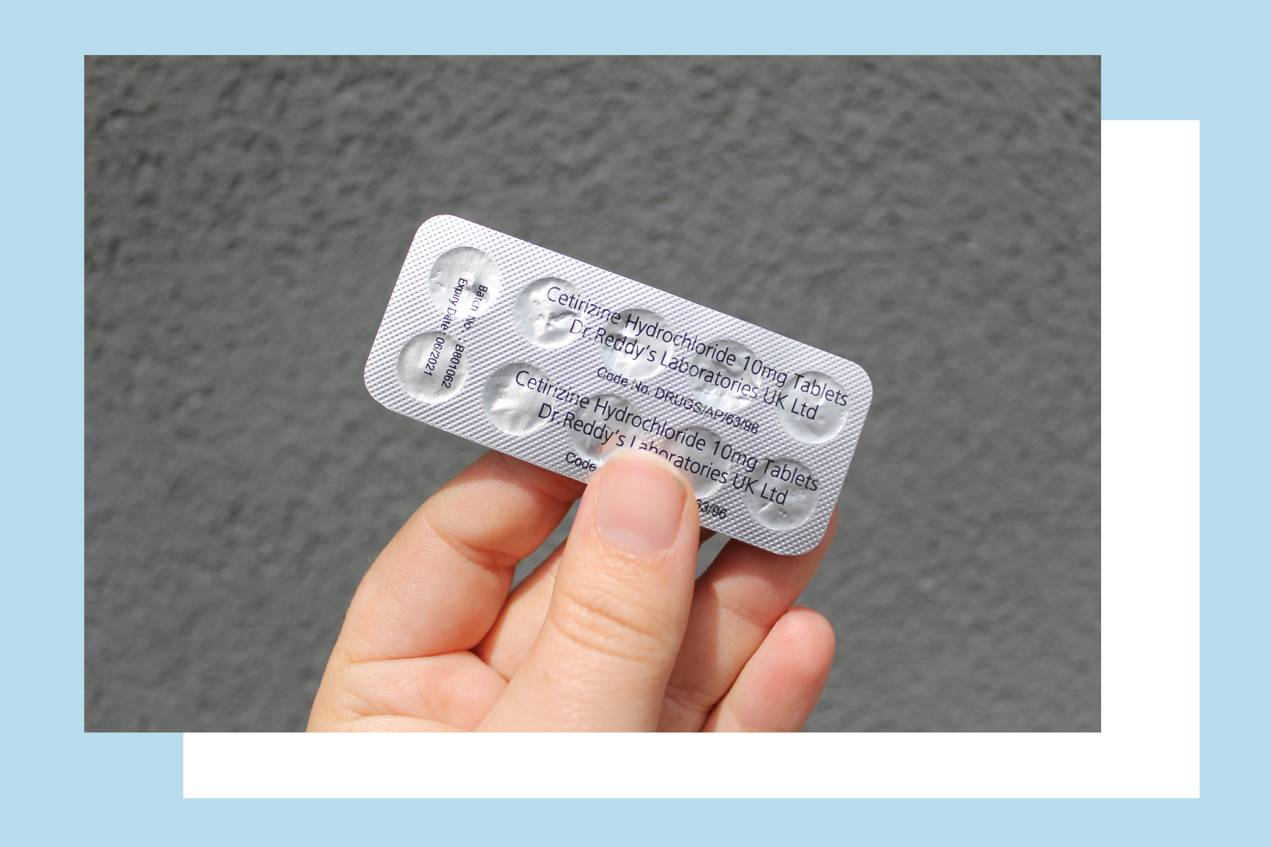 A Close up of a pack of antihistmaines against a grey background