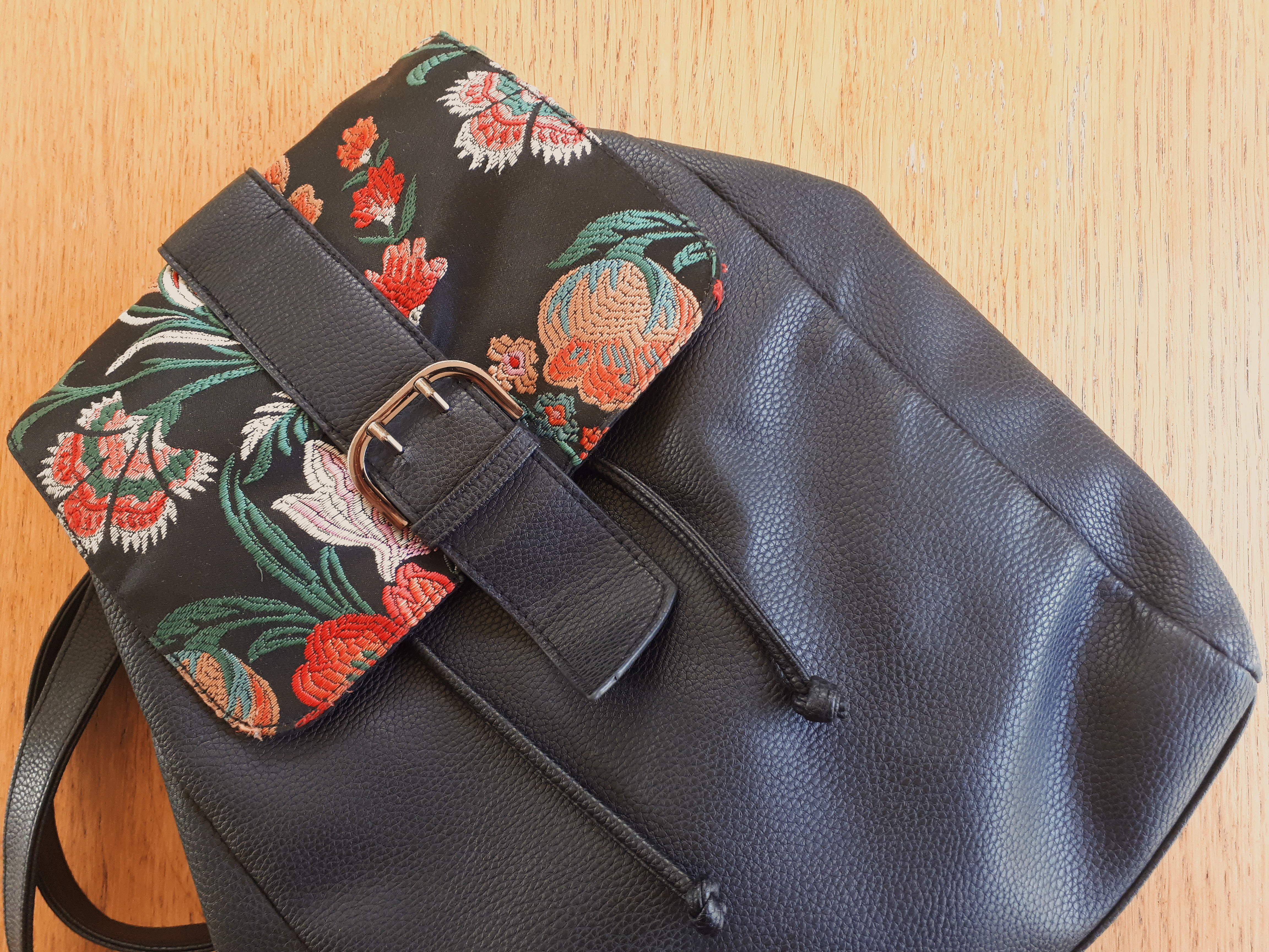 Picture of a black backpack from Primark with a floral detail