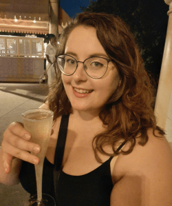 Rosie holding a glass of Fior D’Arancio Moscato