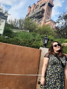 ROsie stood in front of the Tower of Terror, wearing a black and floral swing dress from ASOS, paired with a mesh top