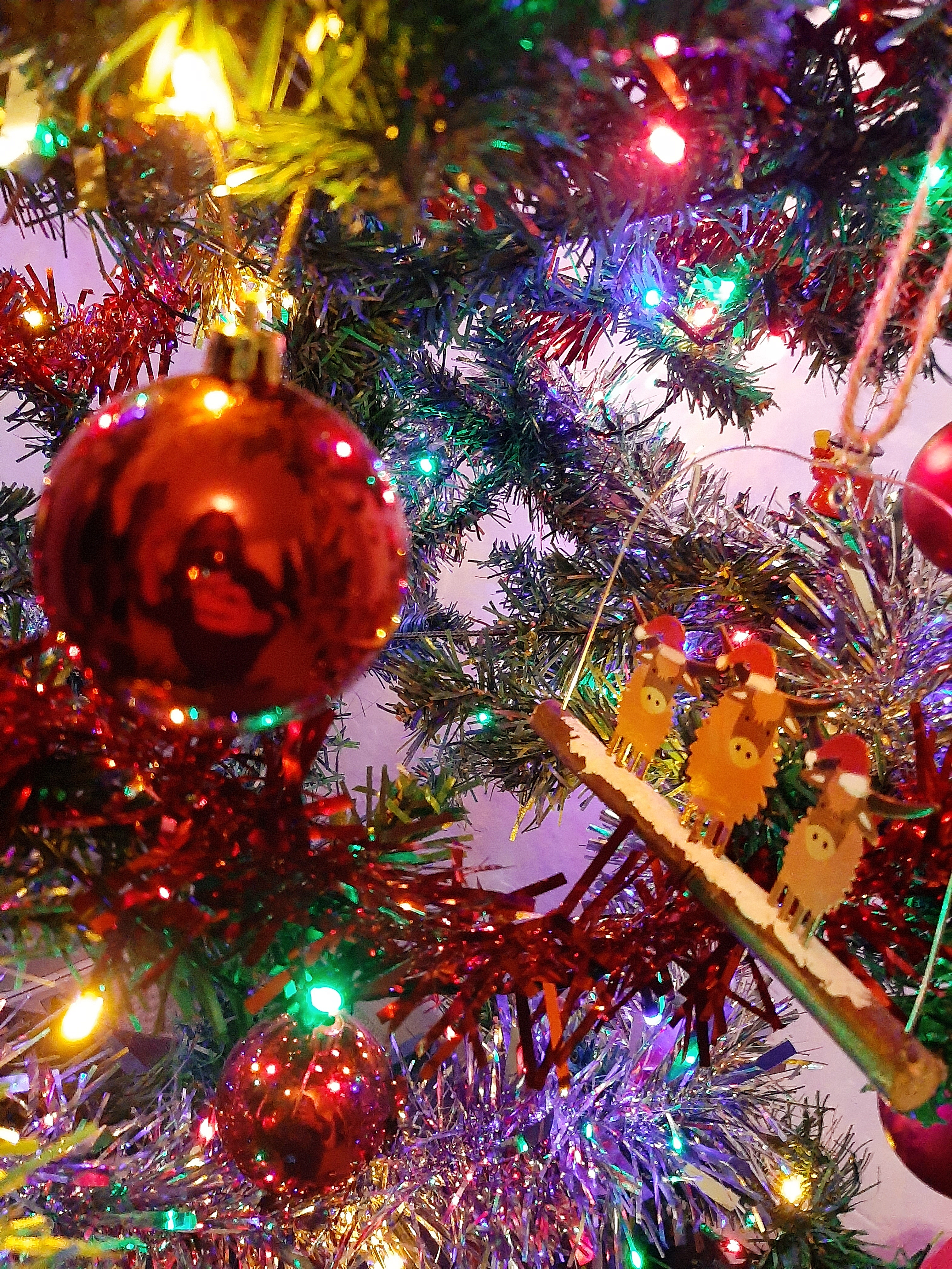 Christmas tree decorated with various baubles and multi-coloured lights