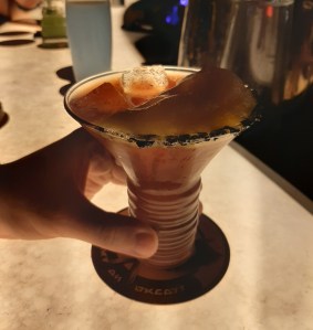 Orange cocktail on a white, light up bar