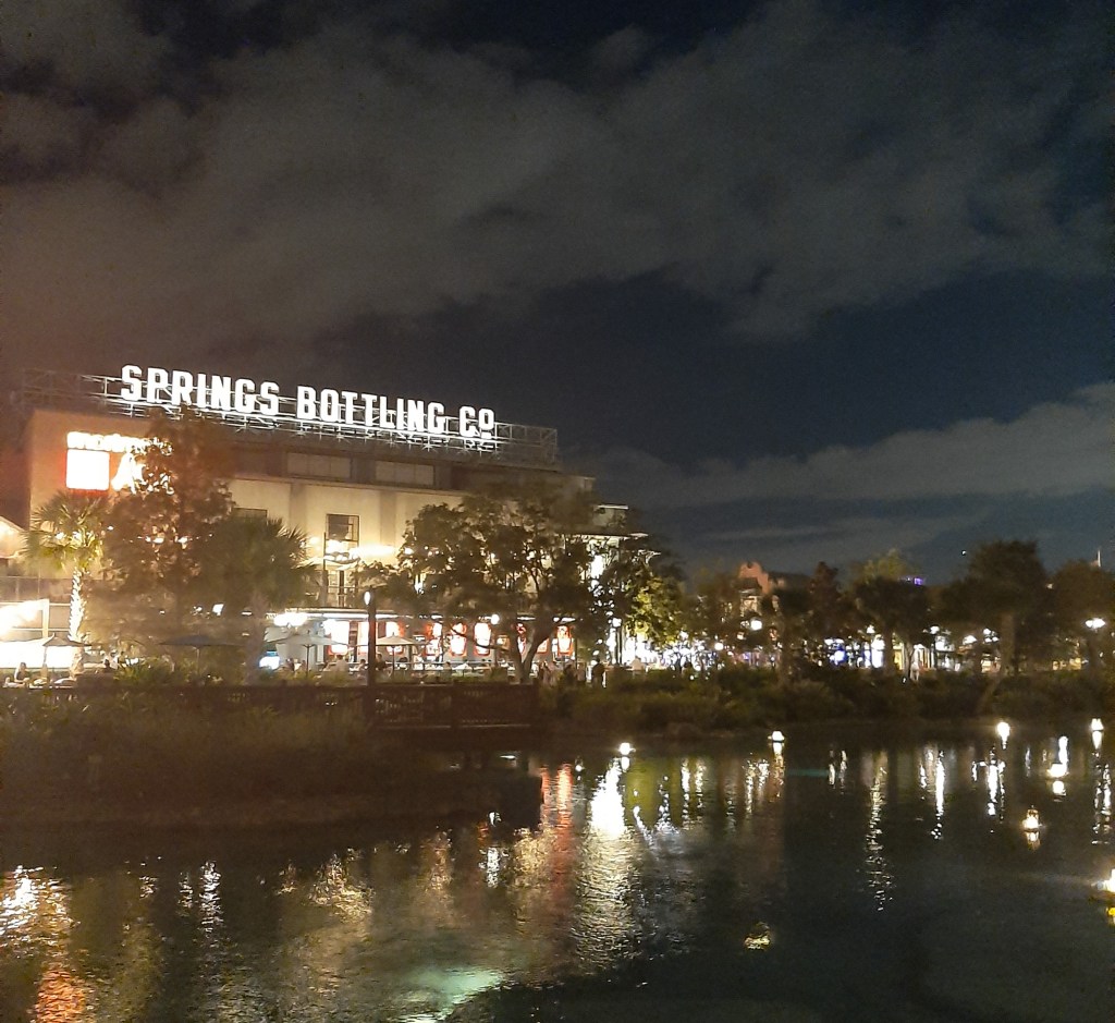 Springs Bottling Co against a dark dusk sky