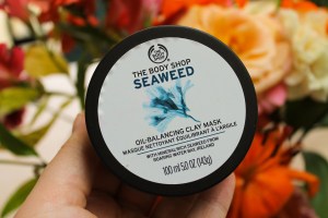 Seaweed Face Mask in front of a bouquet of flowers