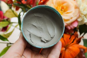 Seaweed Face Mask in front of a bouquet of flowers