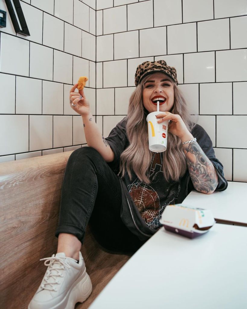 Helen eating McDonalds against a white background