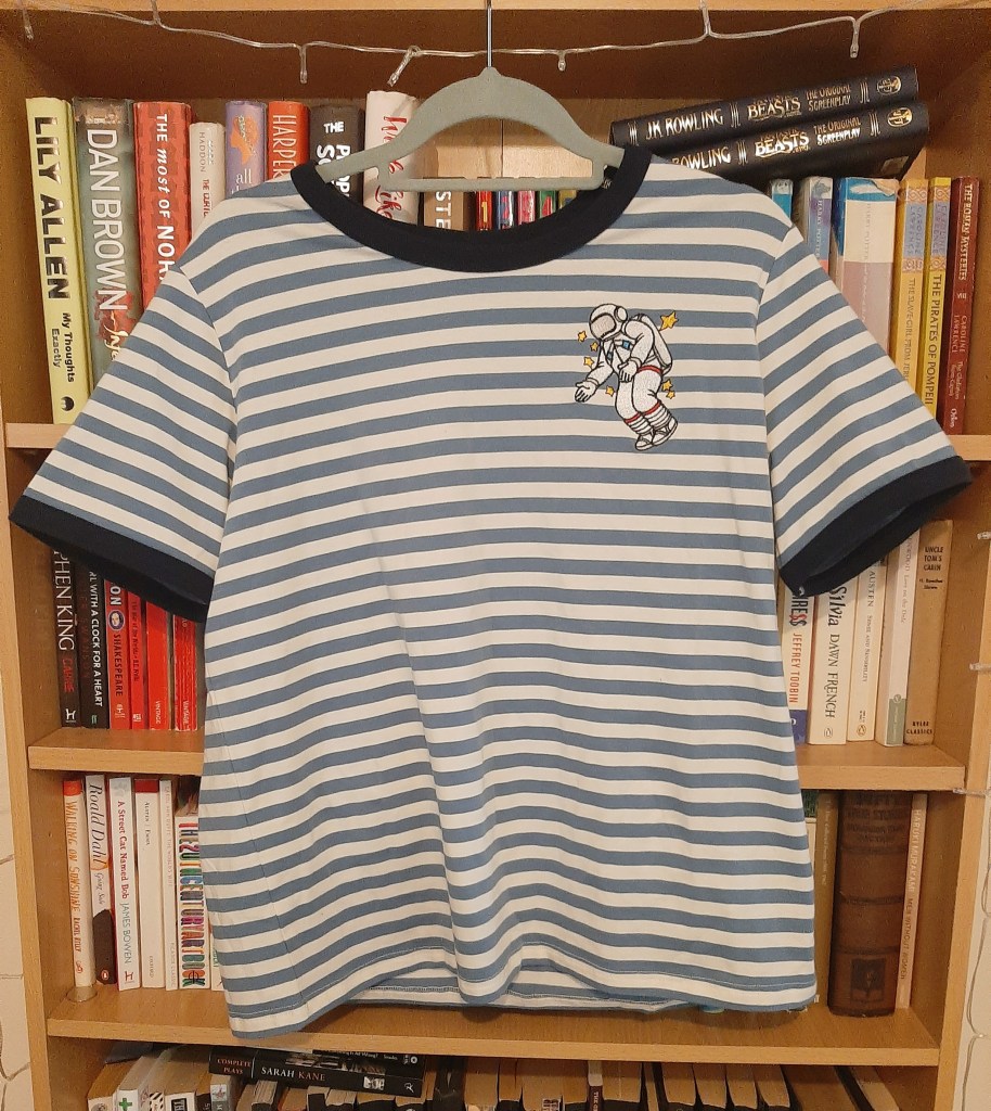 Blue and white striped tee with an embroidered astronaut