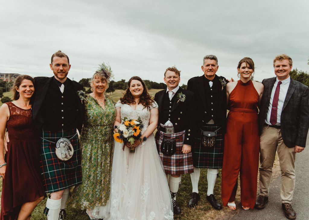 A family group portrait taken at a wedding. 