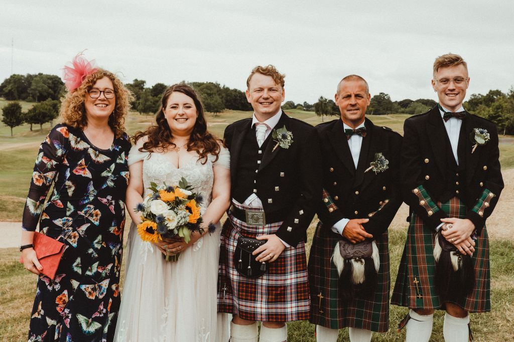 A family group portrait taken at a wedding. 