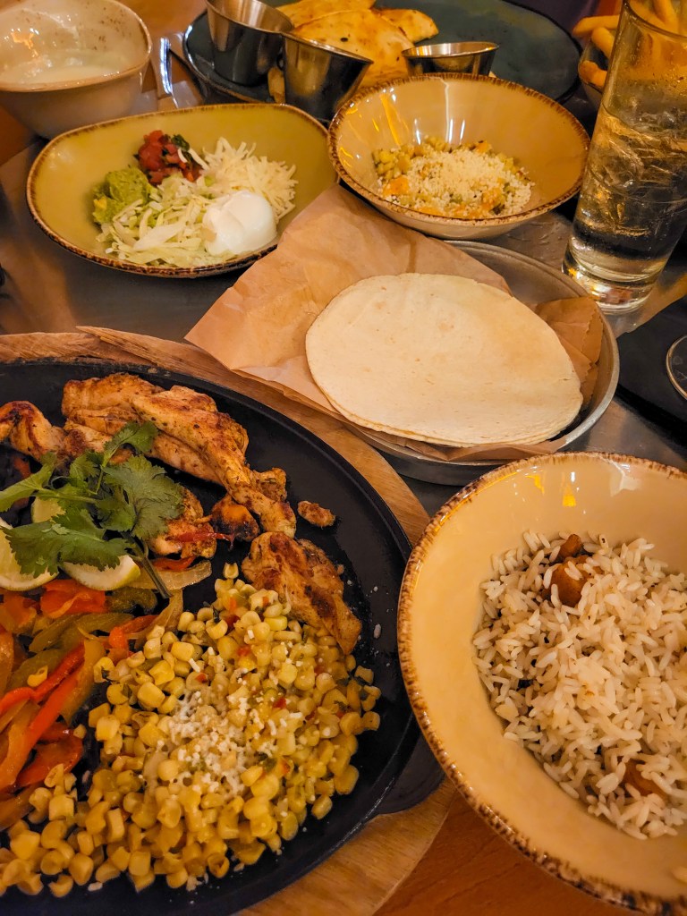 An arrange of Mexican food dishes on a table. 